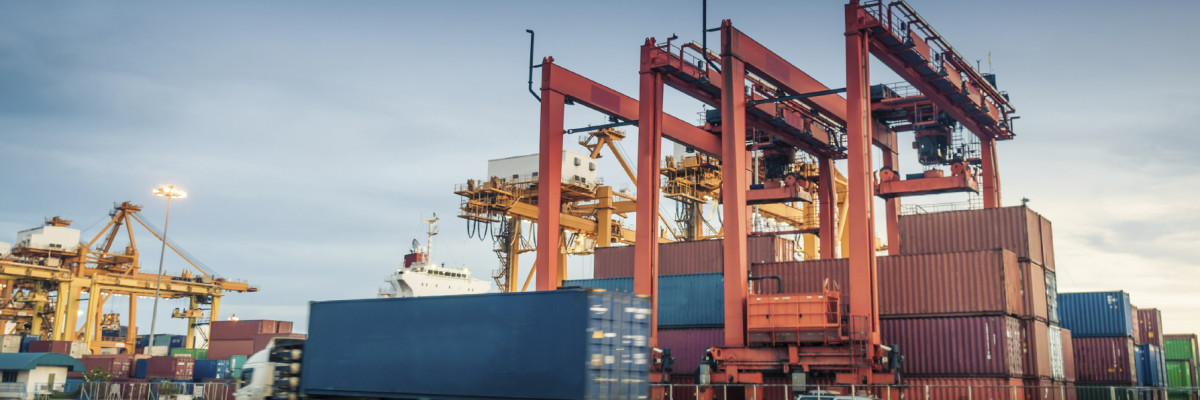 Container ship and truck with container in harbor